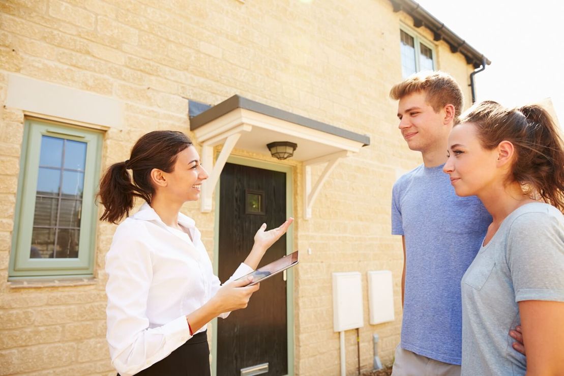 A couple speaking with a financial advisor.